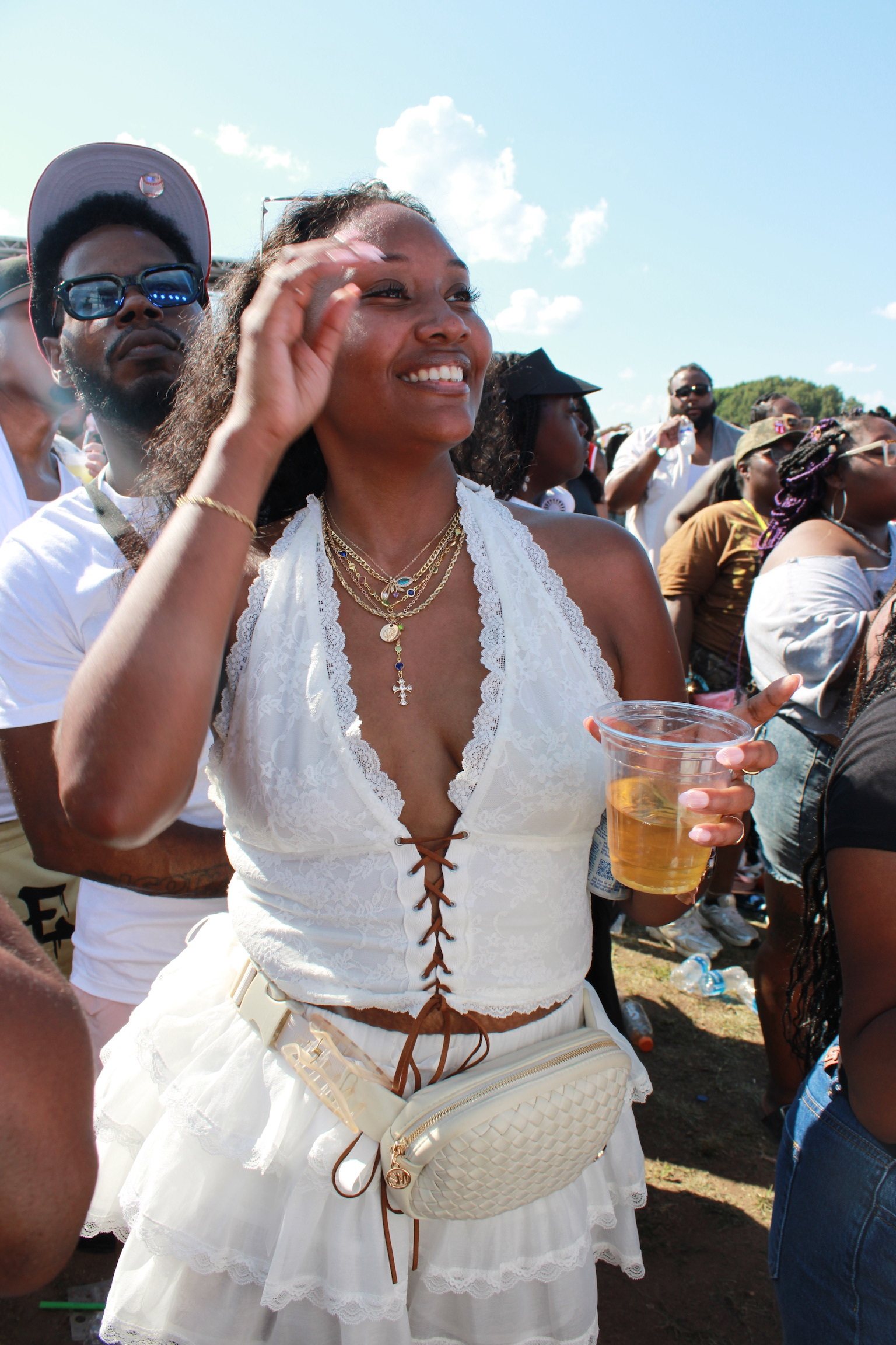 Smiling attendee enjoying an outdoor Be More Grateful festival